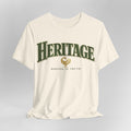 White t-shirt with 'Heritage Rooted in Truth' text and logo on a gray background