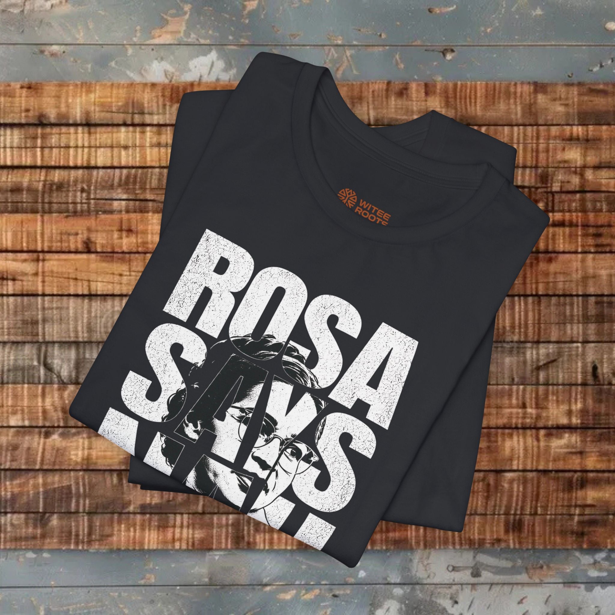 Black t-shirt with 'Rosa Parks' design on a wooden surface