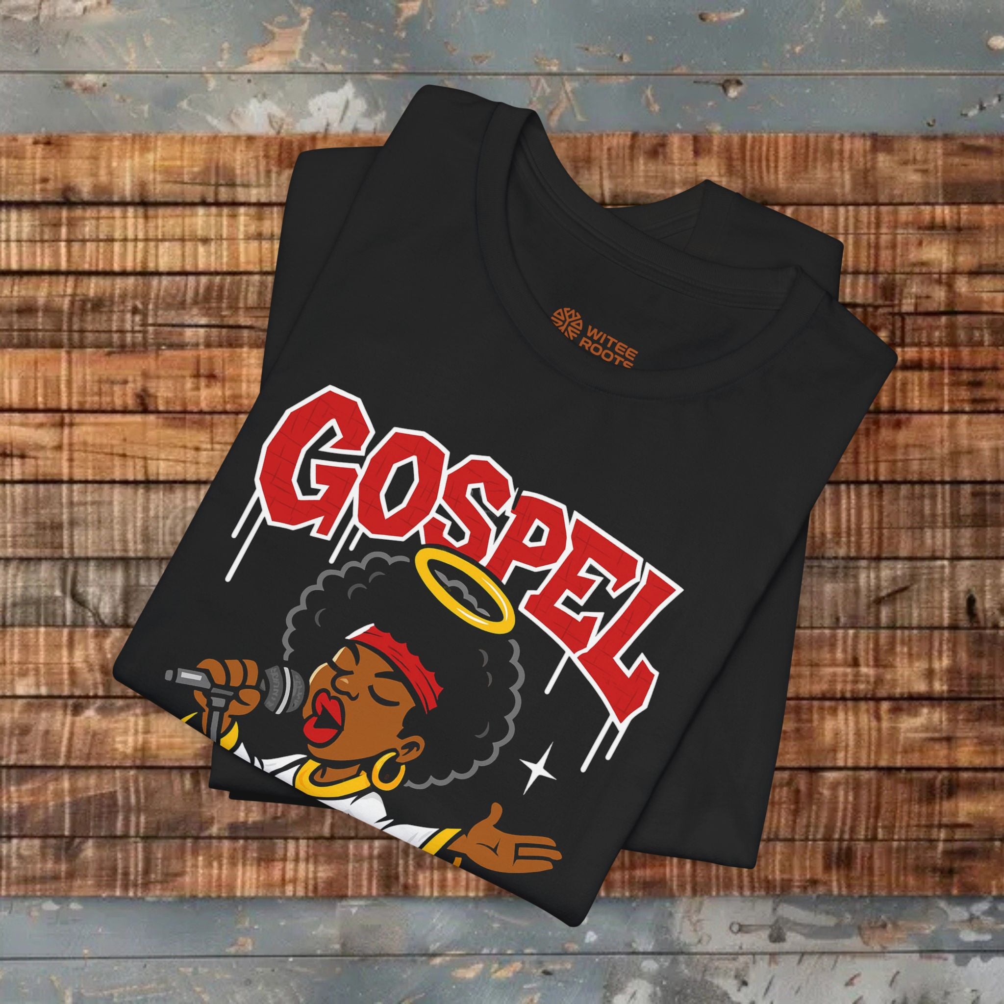Black t-shirt with 'GOSPEL' design on a wooden surface