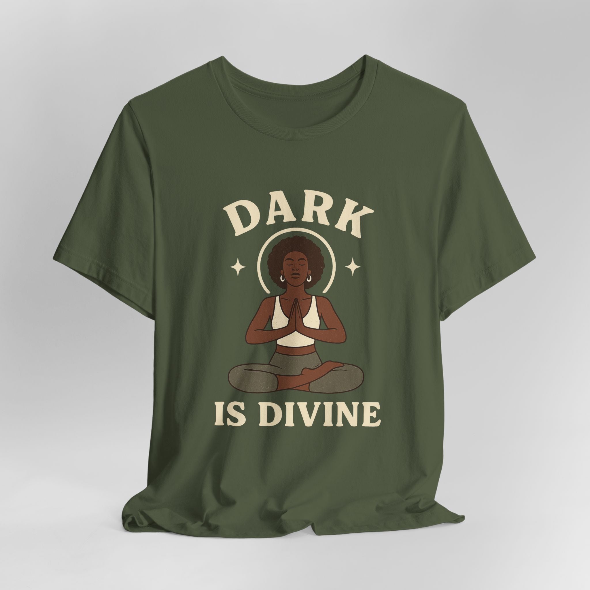 Green t-shirt with a graphic of a person in a meditative pose and 'Dark is Divine' text on a gray background