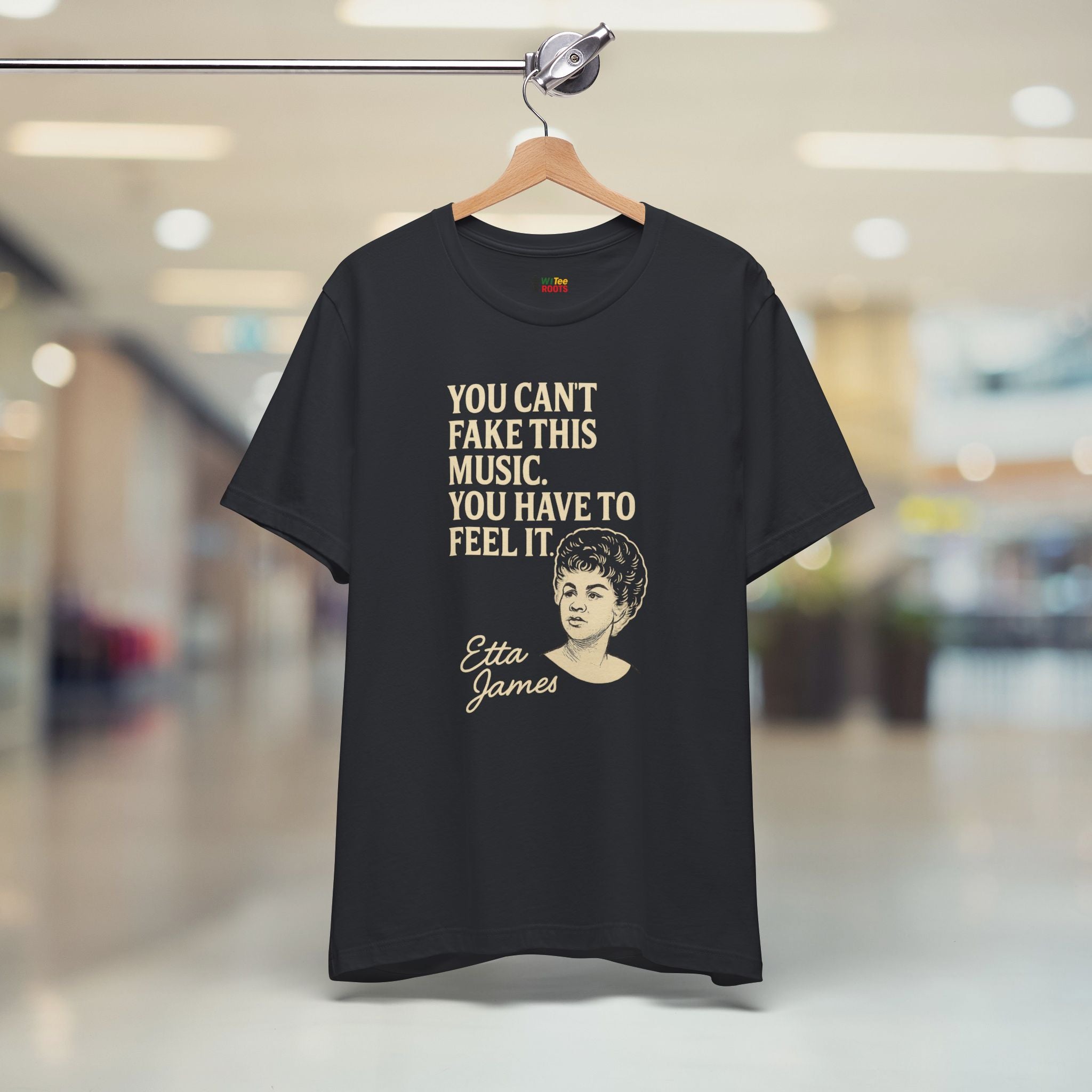 Black t-shirt with Etta James quote on a hanger in a store setting