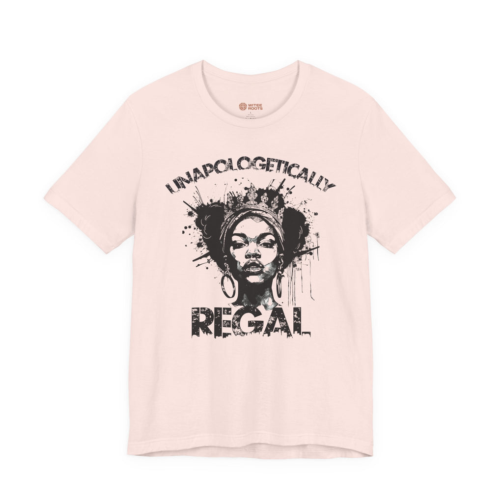 A light pink short-sleeve t-shirt with a black graphic print of a woman's face and the text 'I NAPLOGETICALLY REGAL' on the front, displayed against a solid white background.
