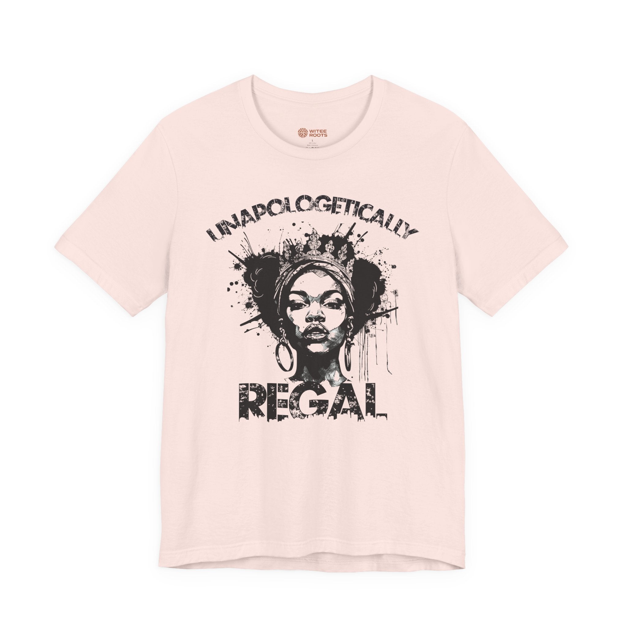 A light pink short-sleeve t-shirt with a black graphic print of a woman's face and the text 'I NAPLOGETICALLY REGAL' on the front, displayed against a solid white background.