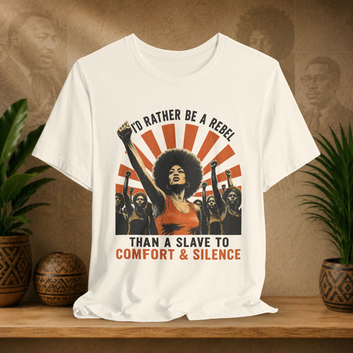 Beige t-shirt with graphic design featuring a woman with raised fist and text on a wooden surface with plants.