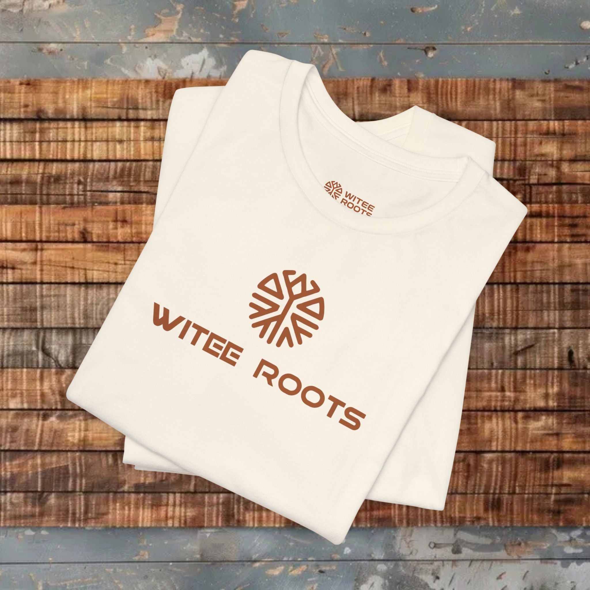 Beige t-shirt with 'WITEE ROOTS' logo on a wooden surface