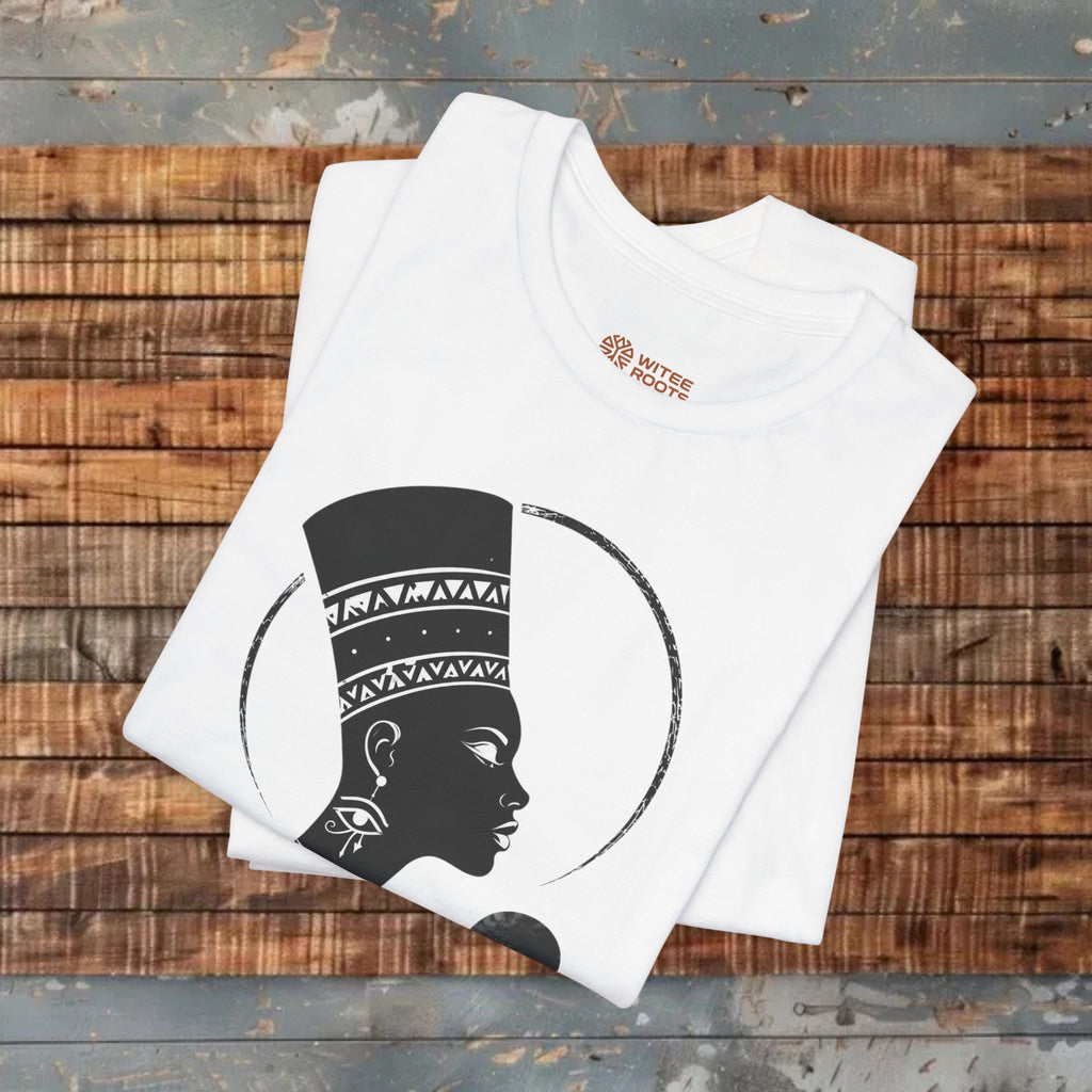 White t-shirt with black graphic design on a wooden surface