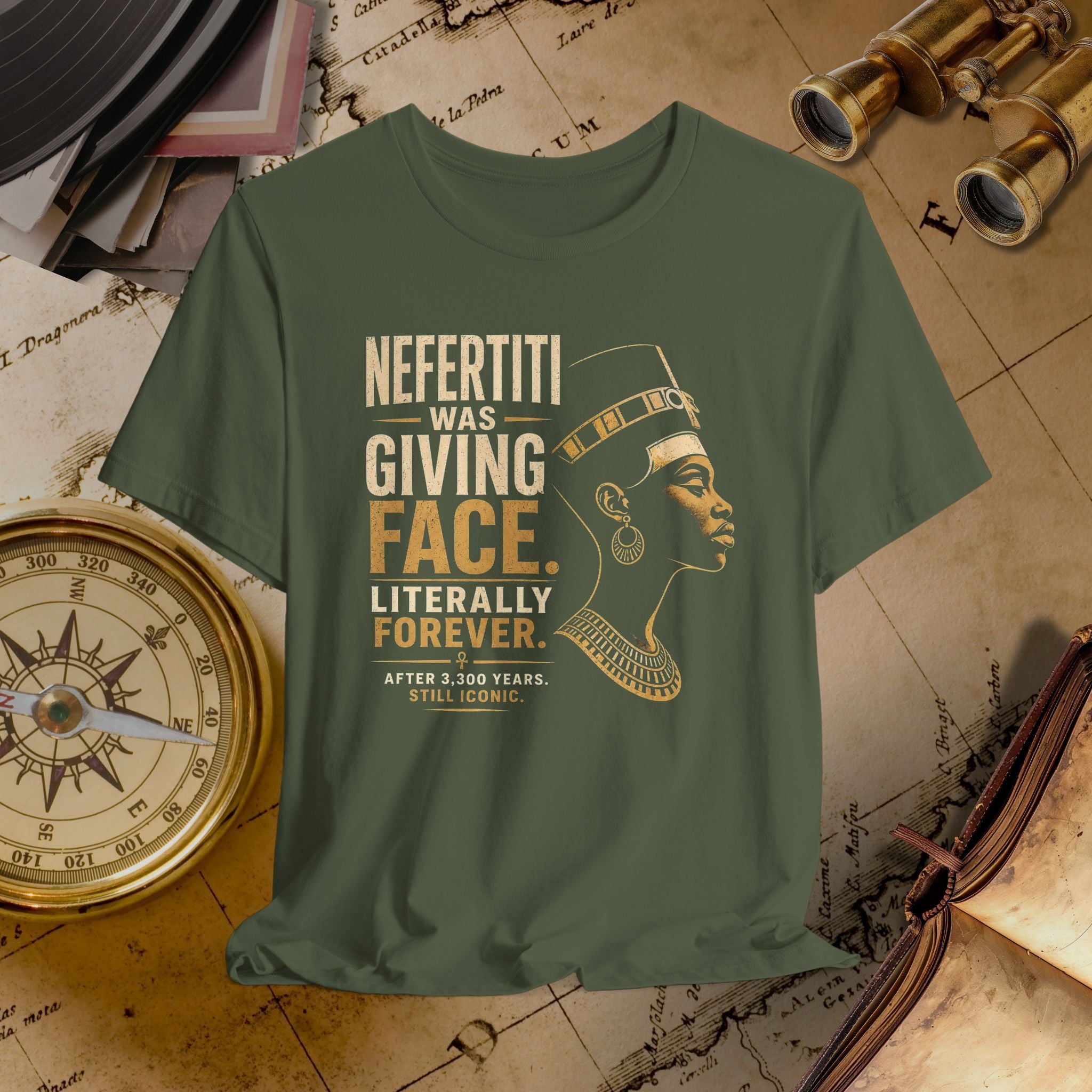 Green t-shirt with gold text and graphic of a historical figure on a vintage map background.