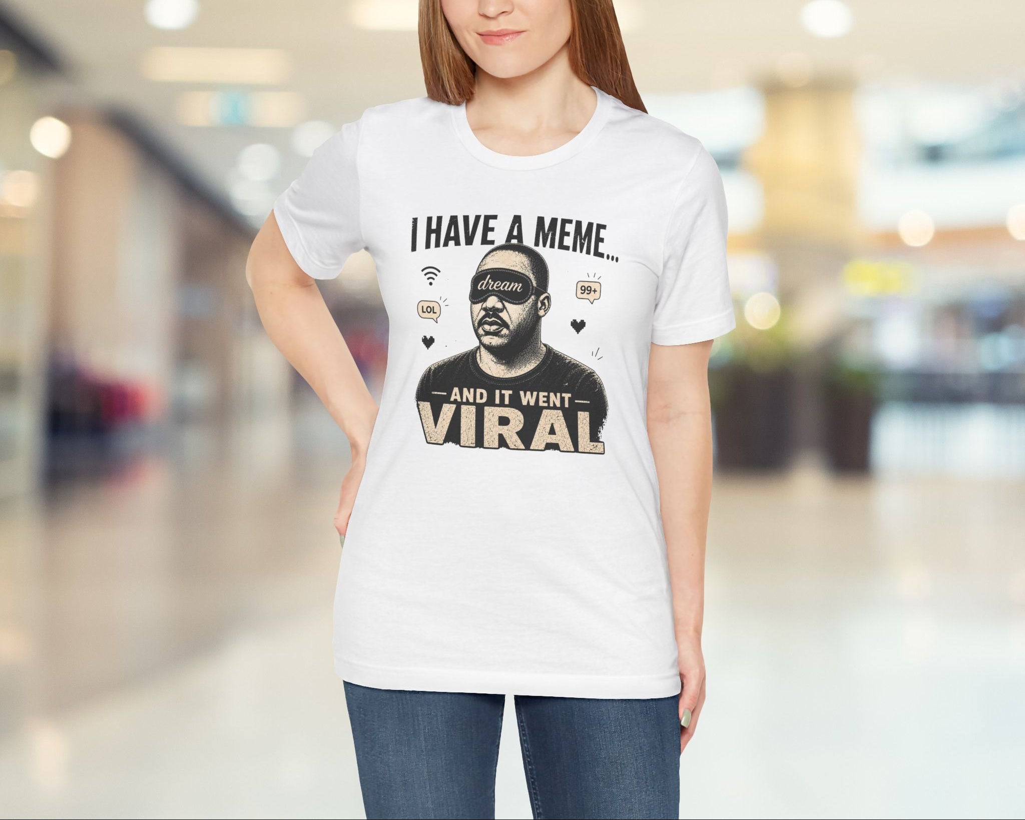Woman wearing a white t-shirt with a graphic and text in a blurred indoor setting