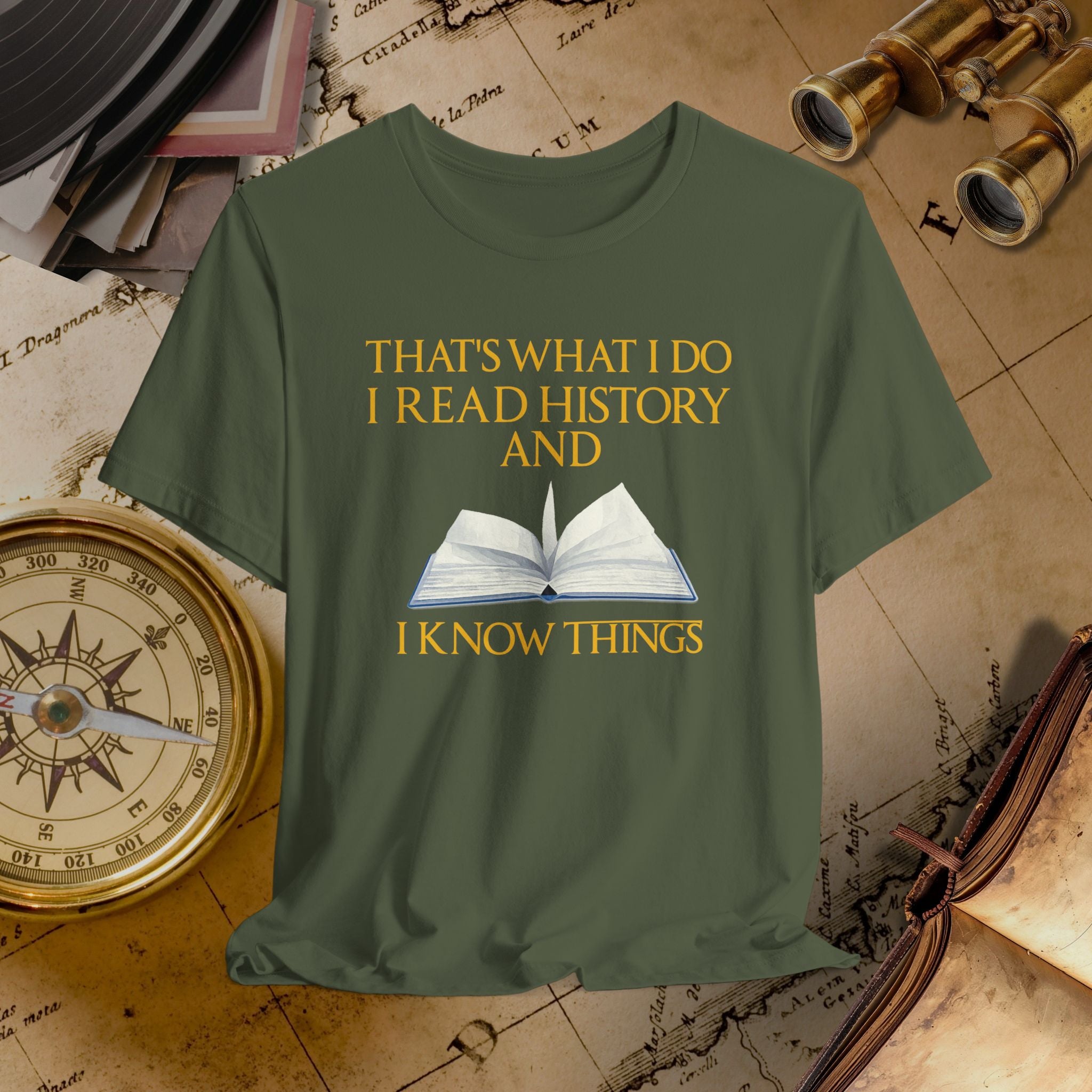 Green t-shirt with book graphic and text on a historical-themed background