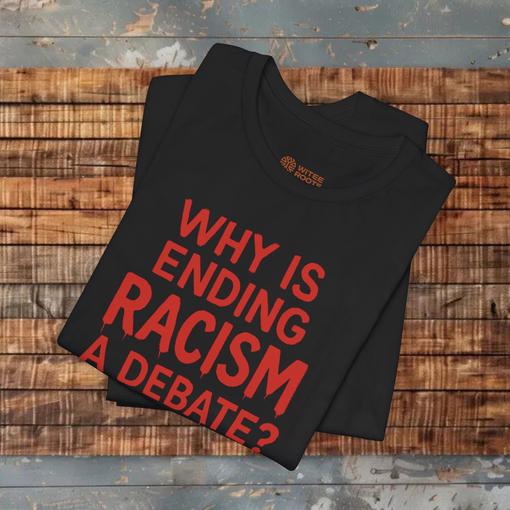 Black t-shirt with red text on a wooden surface