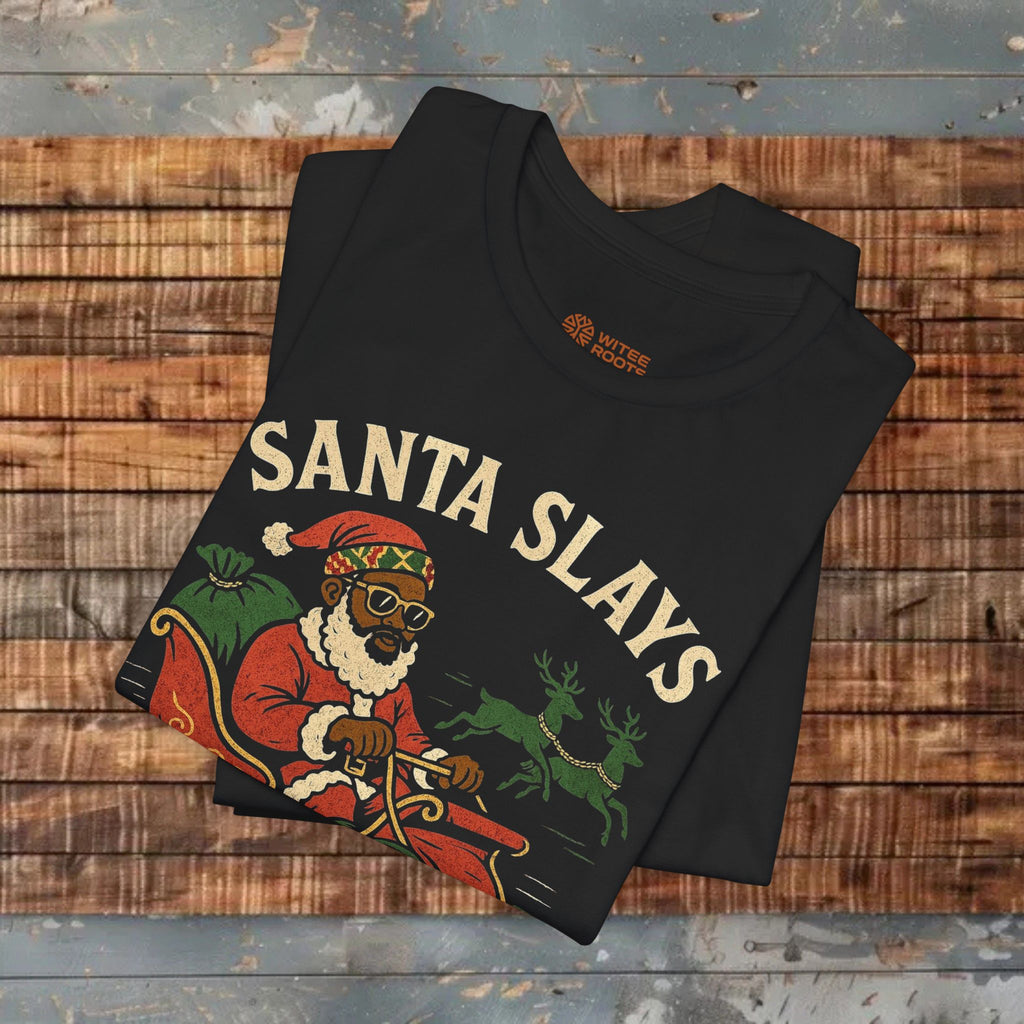 Black t-shirt with 'Santa Slays' design on a wooden surface
