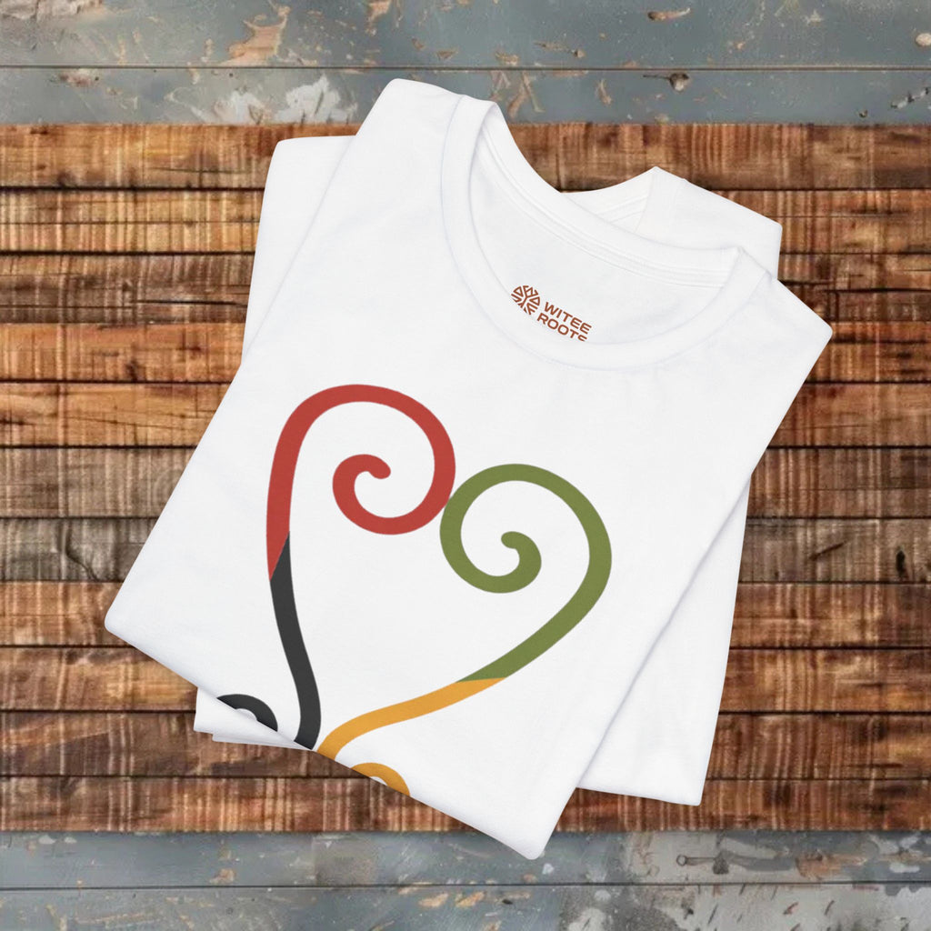 White t-shirt with colorful design on a wooden surface
