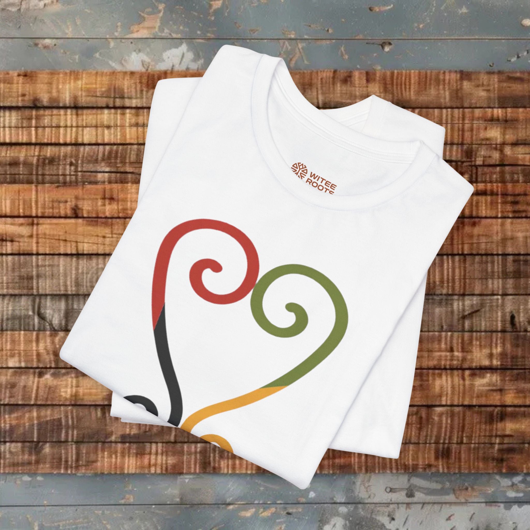 White t-shirt with colorful design on a wooden surface