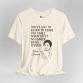 Beige t-shirt with Nina Simone quote on a gray background