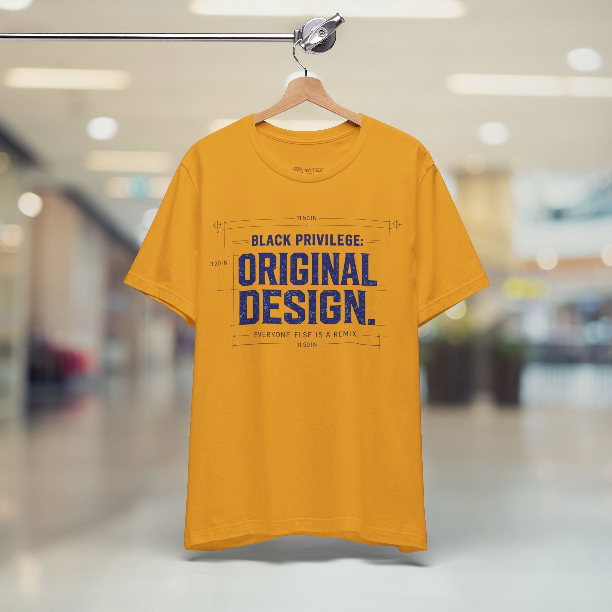 Yellow t-shirt with text on a hanger in a store setting