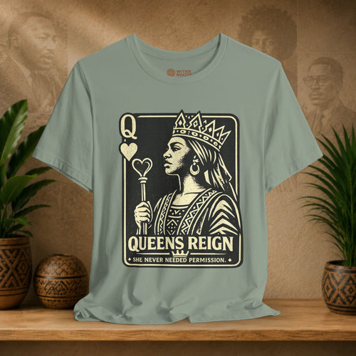 T-shirt with 'Queens Reign' design on a wooden shelf with plants and a textured wall background