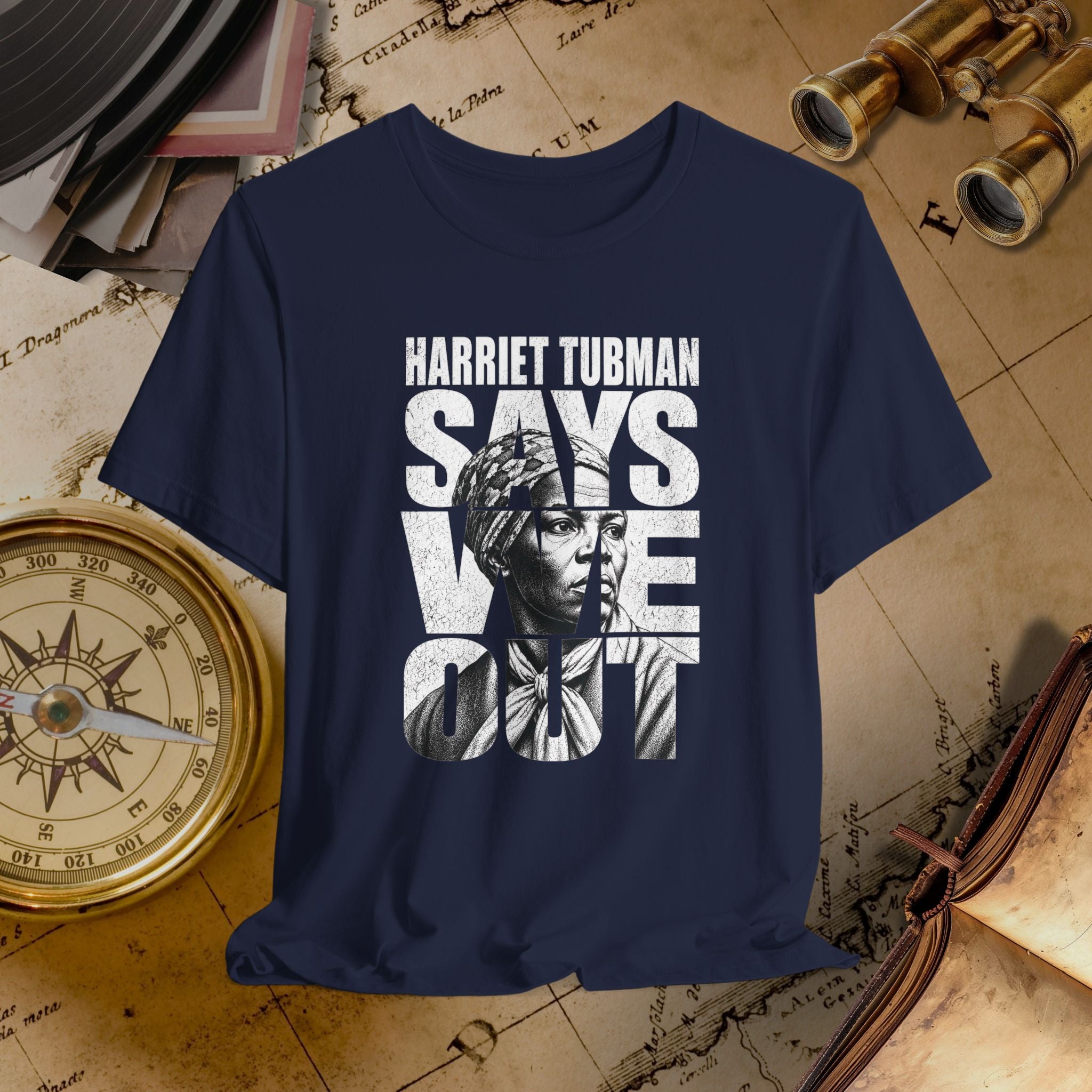 Navy blue t-shirt with Harriet Tubman graphic and 'Harriet Tubman Says We Can' text on a vintage map background.