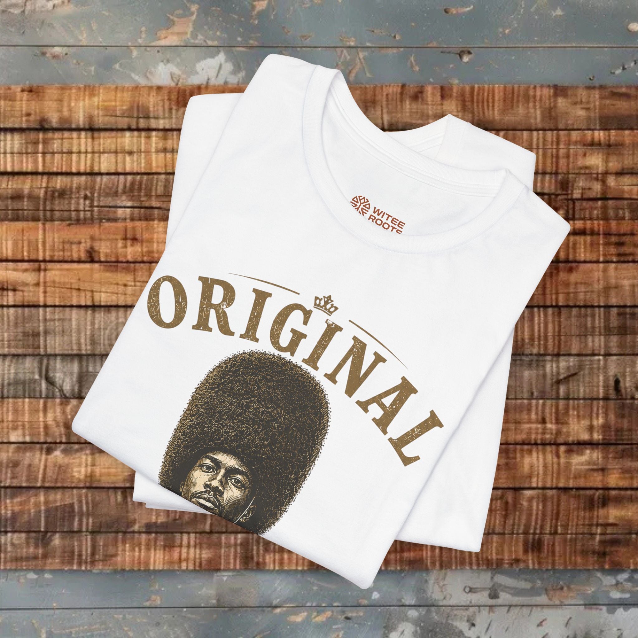 White t-shirt with a graphic design and text on a wooden surface