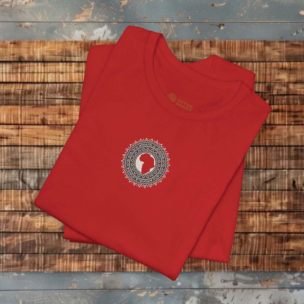 Folded red t-shirt with a circular design on a wooden surface
