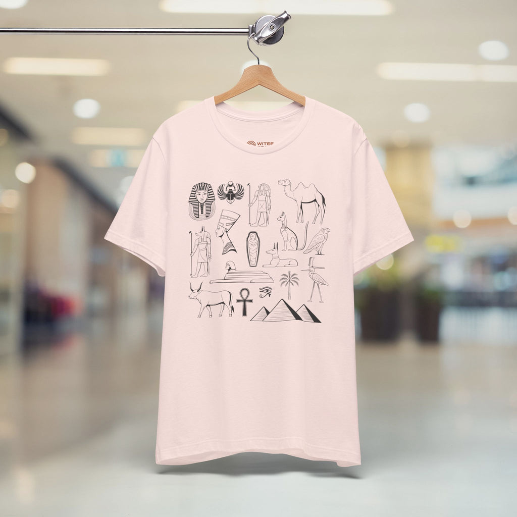 Pink t-shirt with hieroglyphics design on a hanger in a store setting
