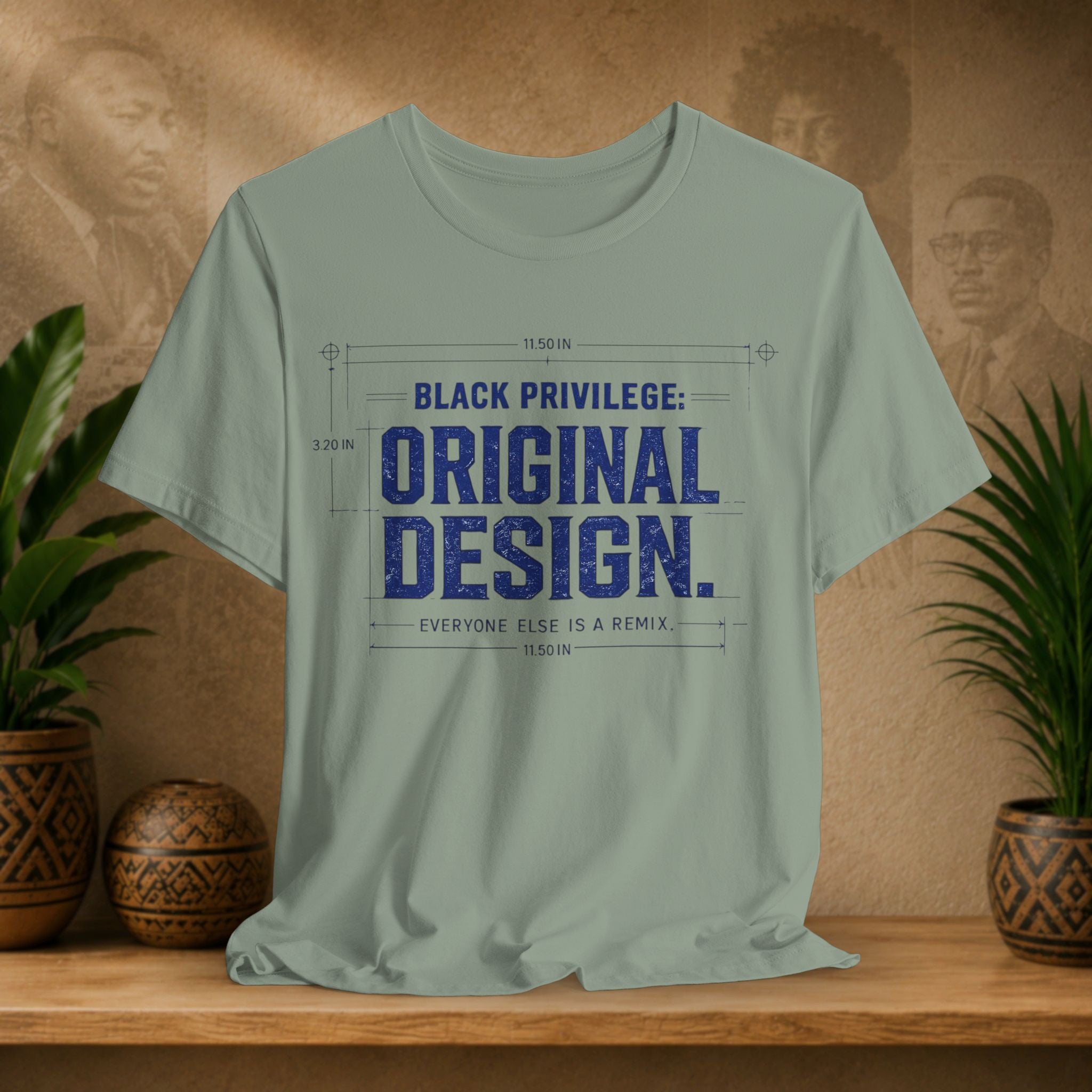 Green t-shirt with blue text on a wooden surface with plants and a textured wall background