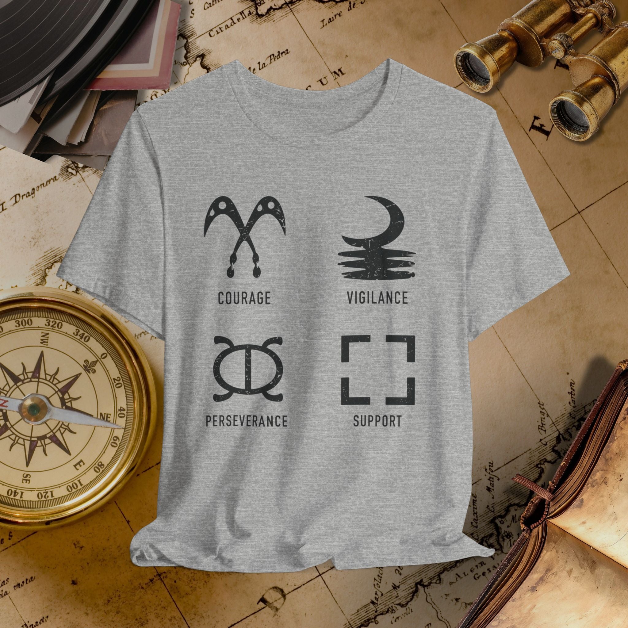 Gray t-shirt with motivational symbols and text on a vintage map background