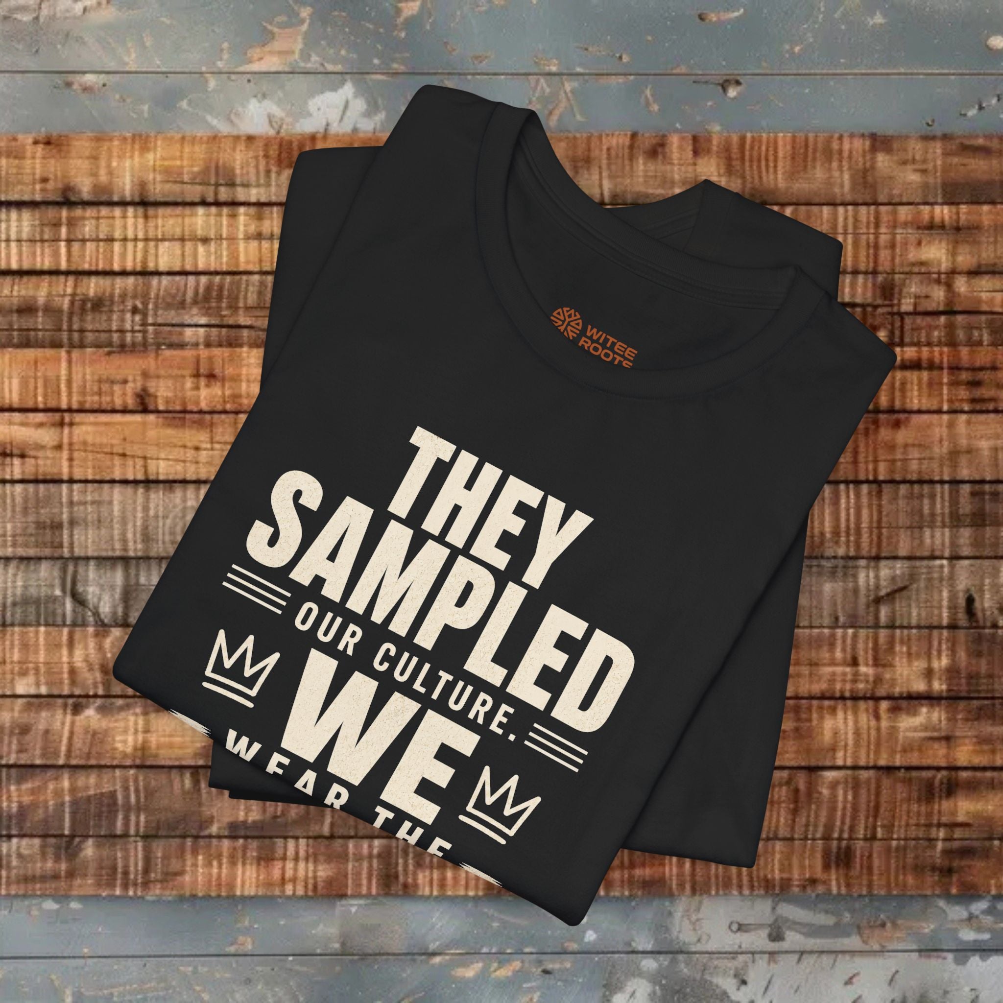 Black folded T-shirt on wooden background  