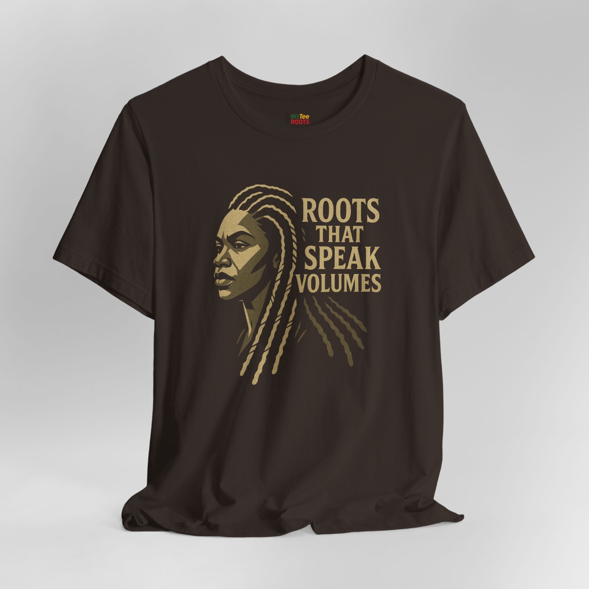 Black t-shirt with a graphic of a woman's face and 'Roots That Speak Volumes' text on a gray background
