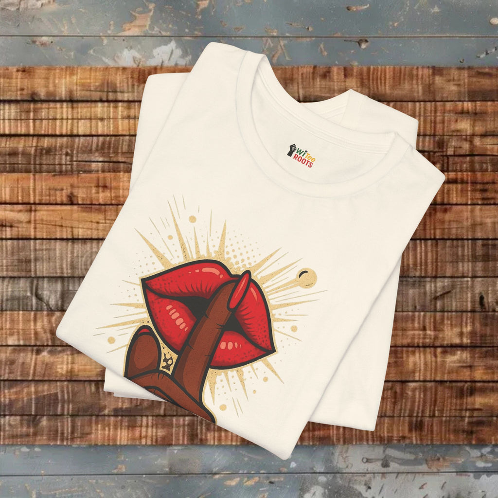 Beige t-shirt with red and brown graphic design on a wooden surface