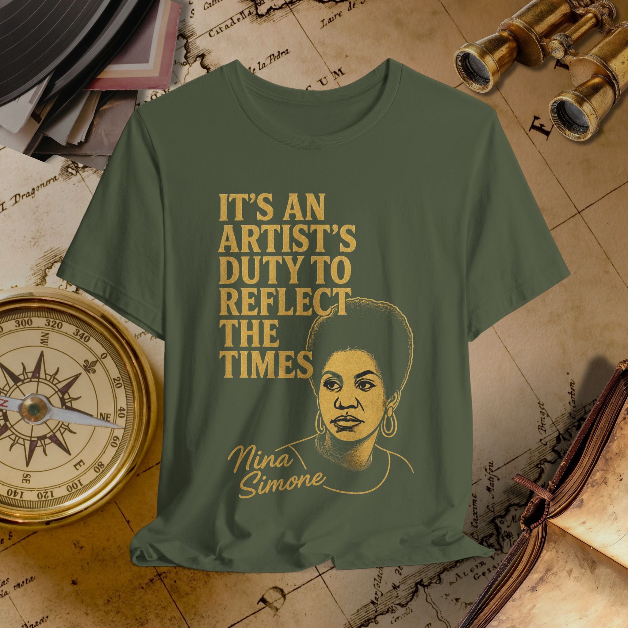 Green t-shirt with a graphic of a woman and text on a vintage map background