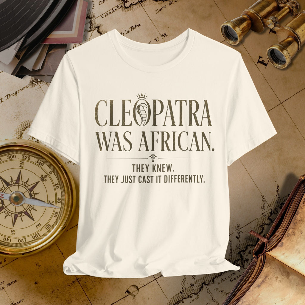 Beige t-shirt with 'Cleopatra was African' text on a vintage map background