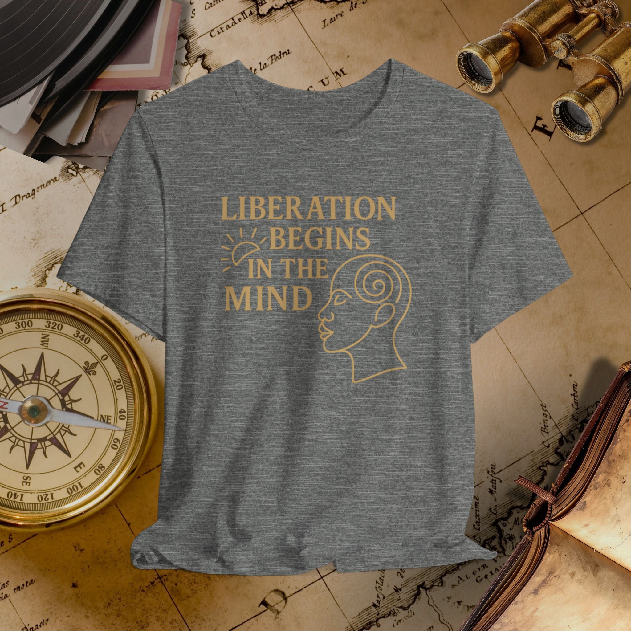 Gray t-shirt with 'Liberation Begins in the Mind' text and graphic on a vintage map background.
