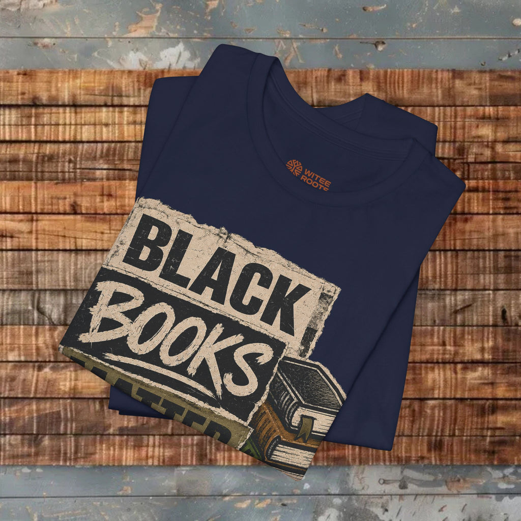 Folded navy blue t-shirt with 'Black Books' graphic on a wooden surface