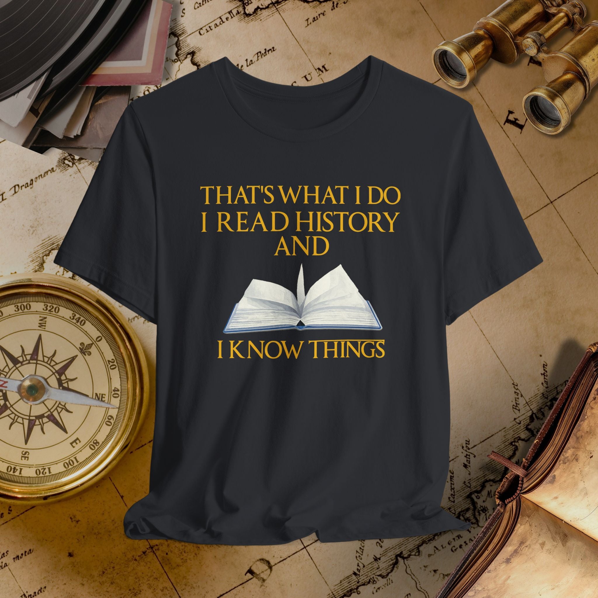Black t-shirt with 'I Read History and I Know Things' text and book graphic on a historical-themed background.