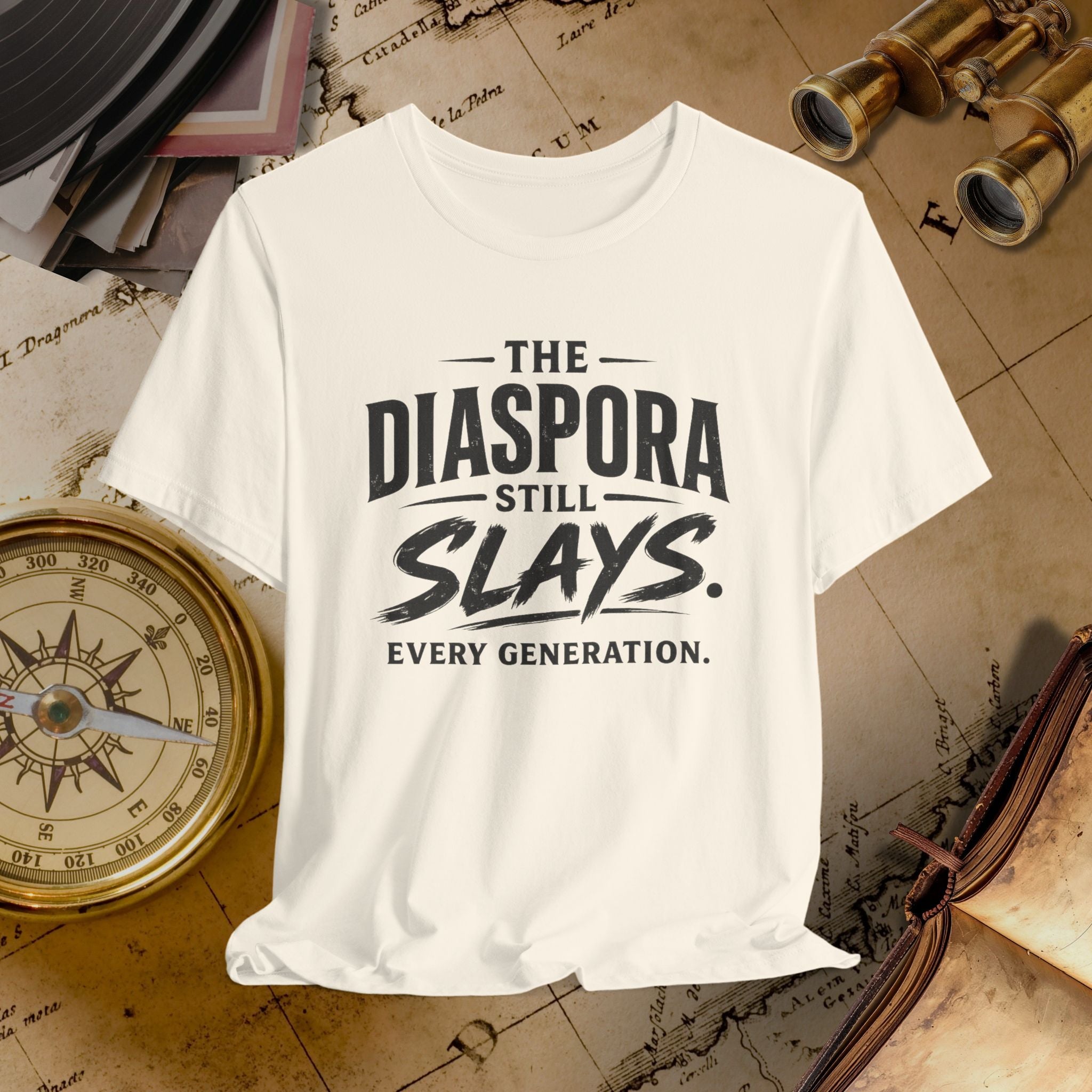 Beige t-shirt with 'The Diaspora Still Slays Every Generation' text on a vintage map background.