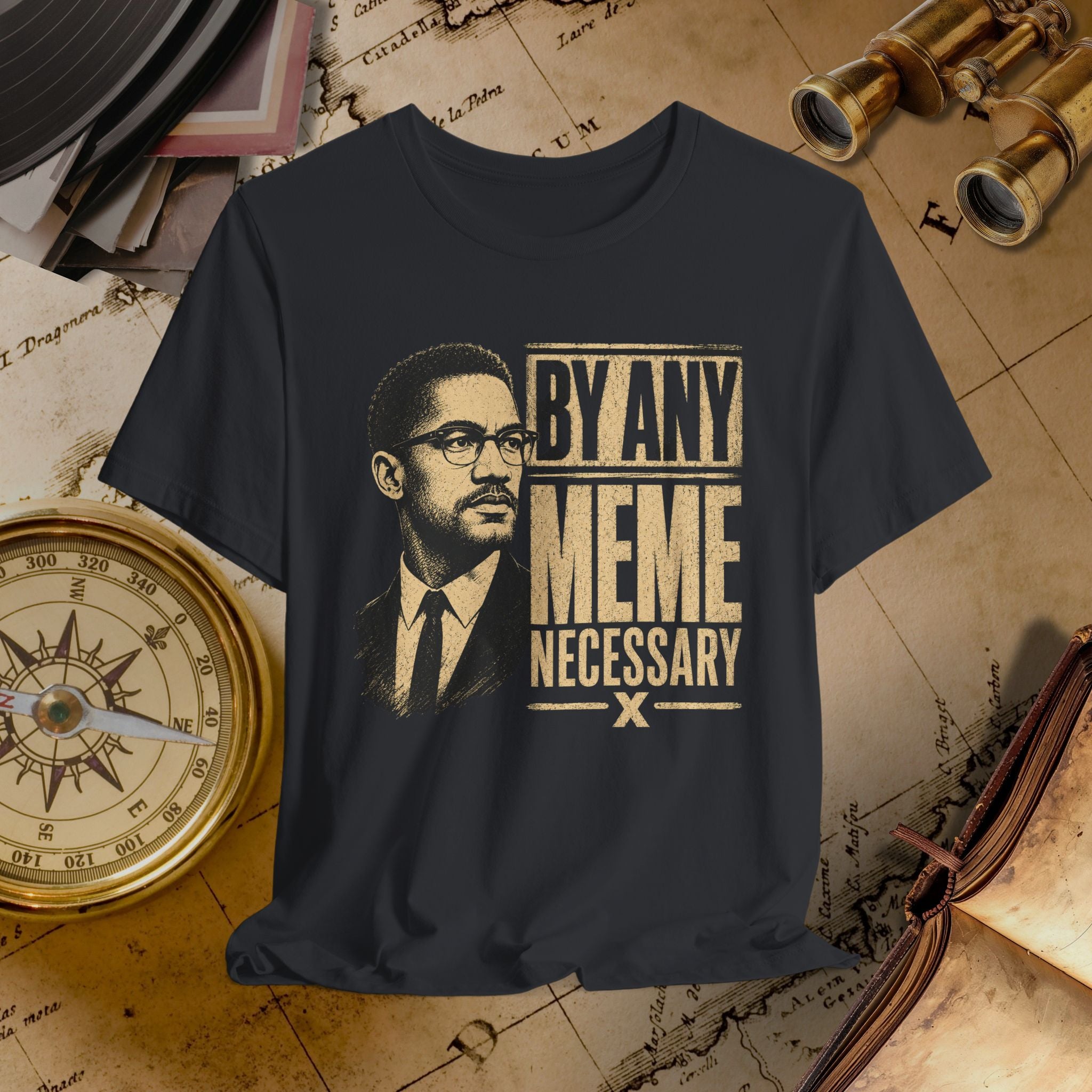 Black t-shirt with a graphic of a man and text 'By Any Meme Necessary' on an old map background.