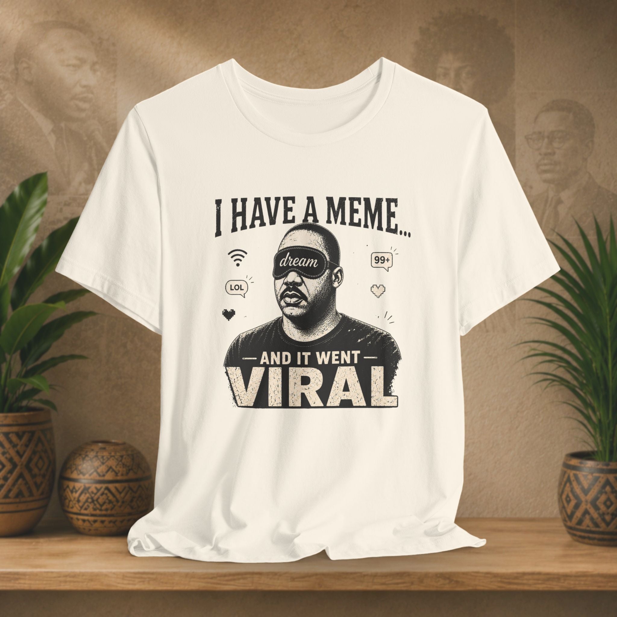 Beige t-shirt with graphic design and text on a wooden surface with plants and a brown background