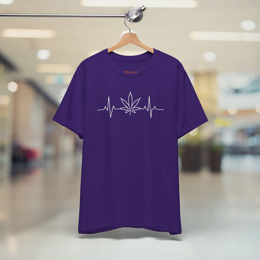 Purple t-shirt with a cannabis leaf design on a hanger in a store setting