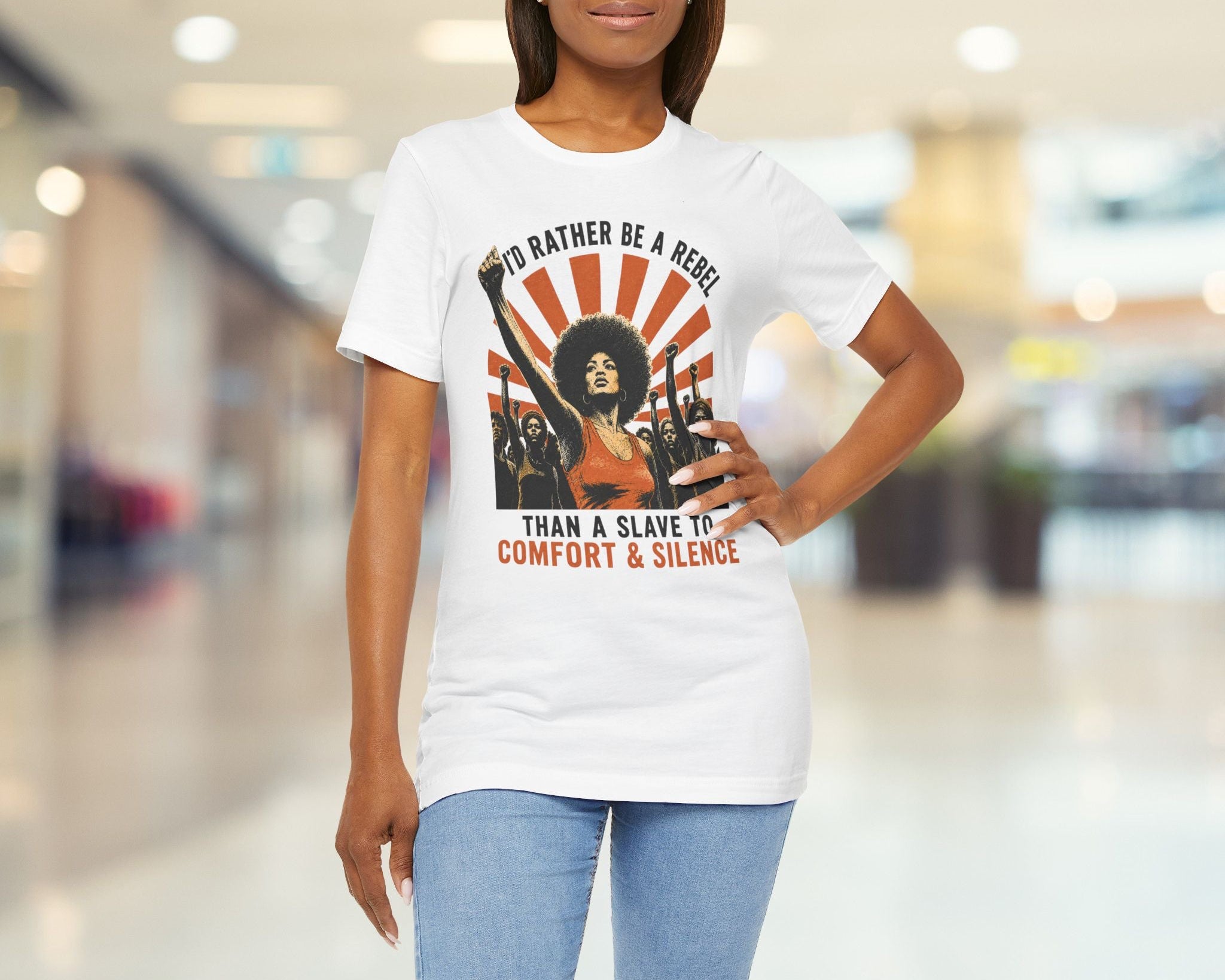 Woman wearing a white t-shirt with a graphic design in a blurred indoor setting