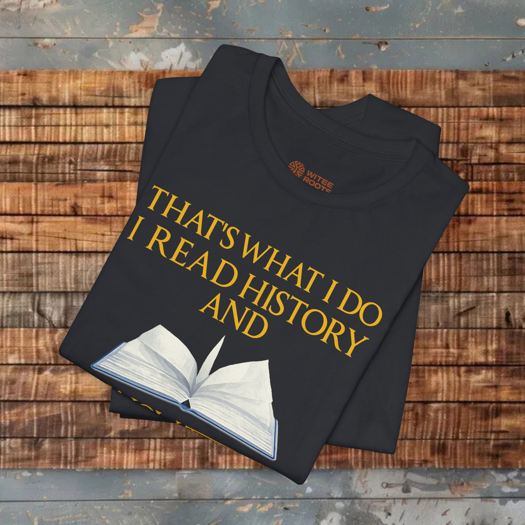 Black t-shirt with yellow text and book graphic on a wooden surface