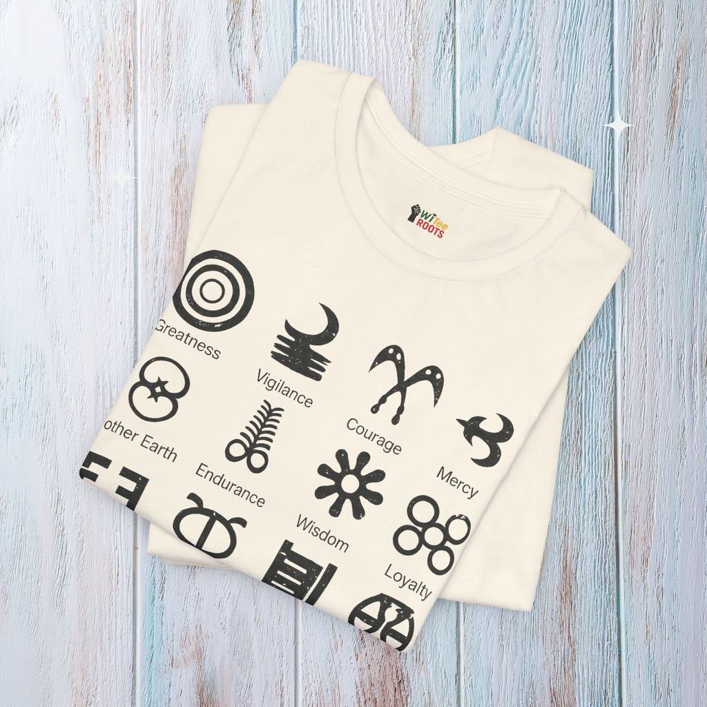 Folded t-shirt with black symbols and text on a light wooden surface