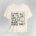 Cream t-shirt with a skeleton holding a clock and text on a gray background