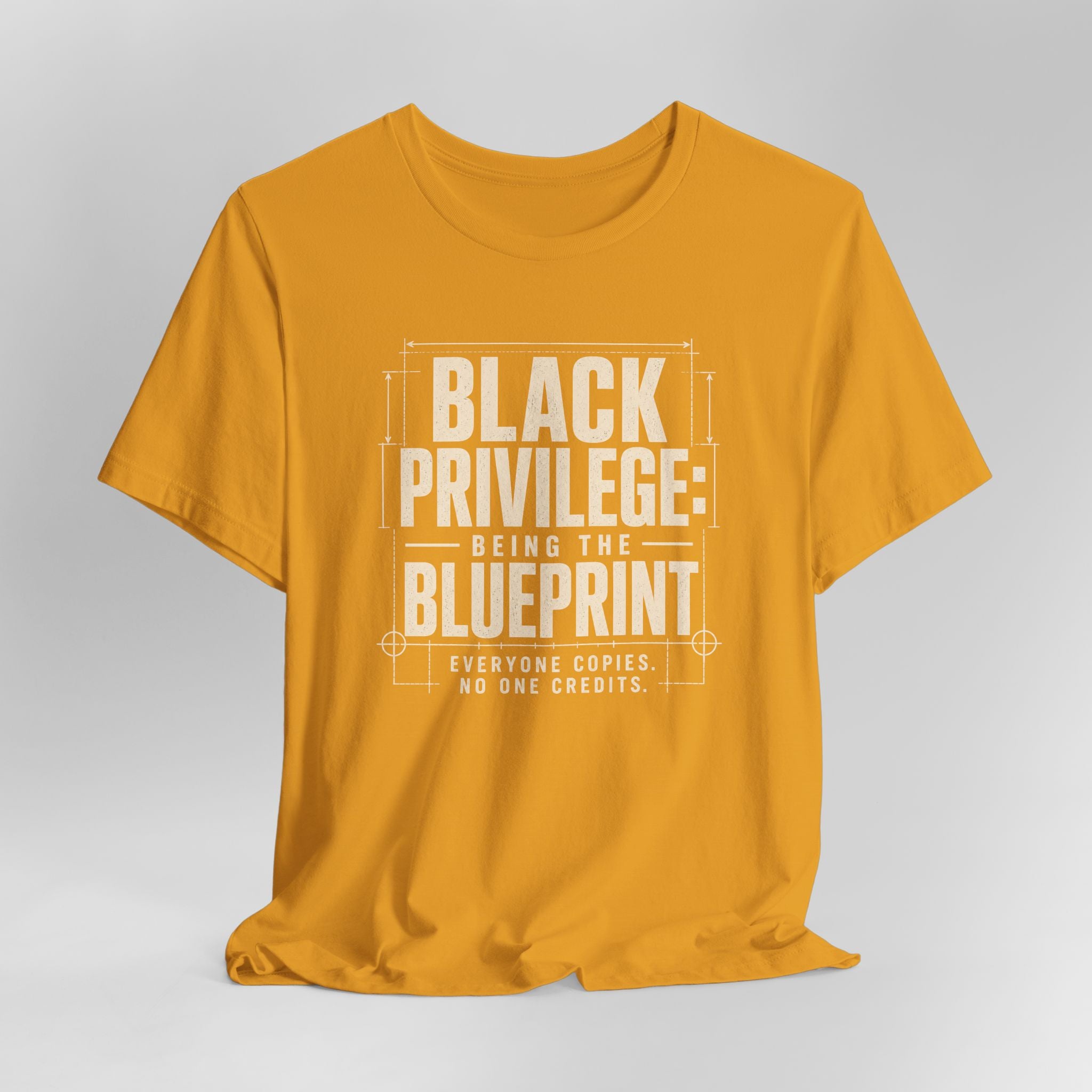 Mustard t-shirt with white text on a gray background