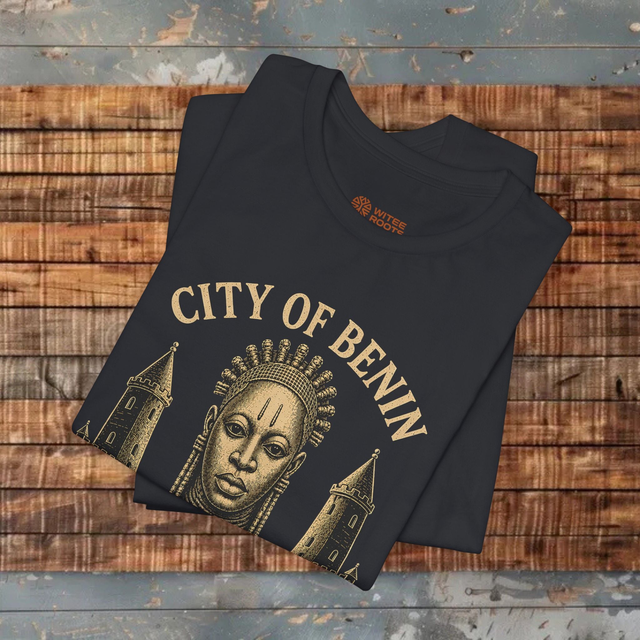 Black t-shirt with 'City of Benin' design on a wooden surface