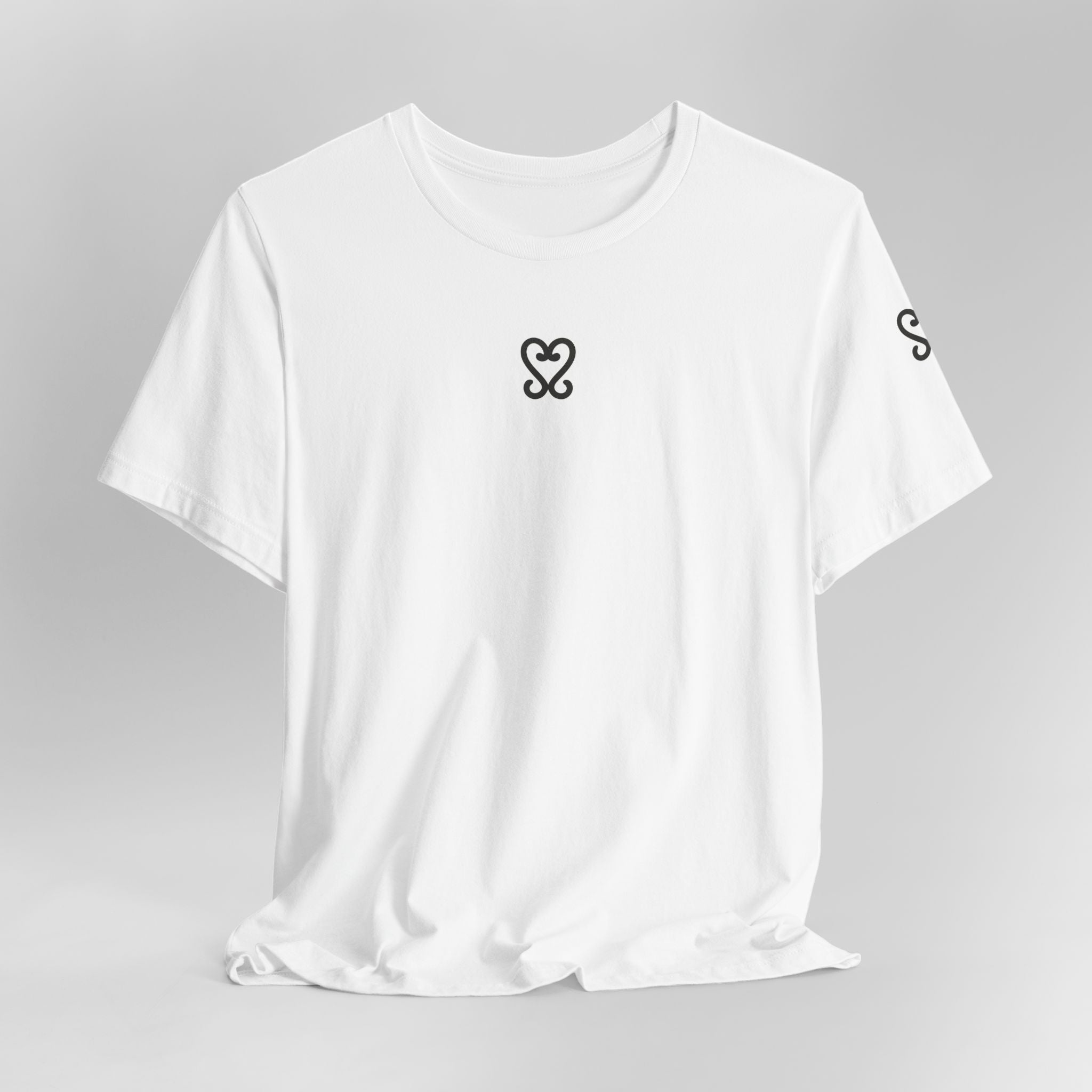 White t-shirt with black heart and circle design on a gray background