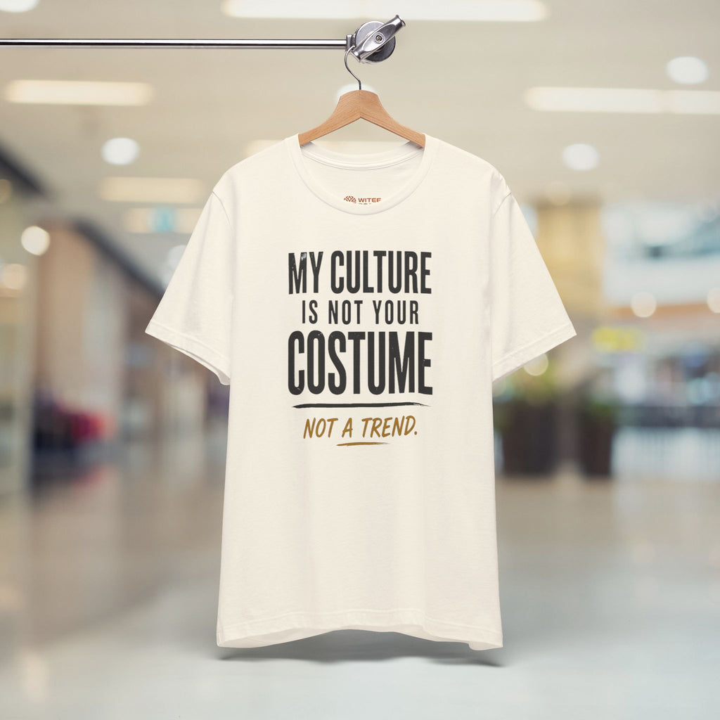 Beige t-shirt with text on a hanger in a store setting