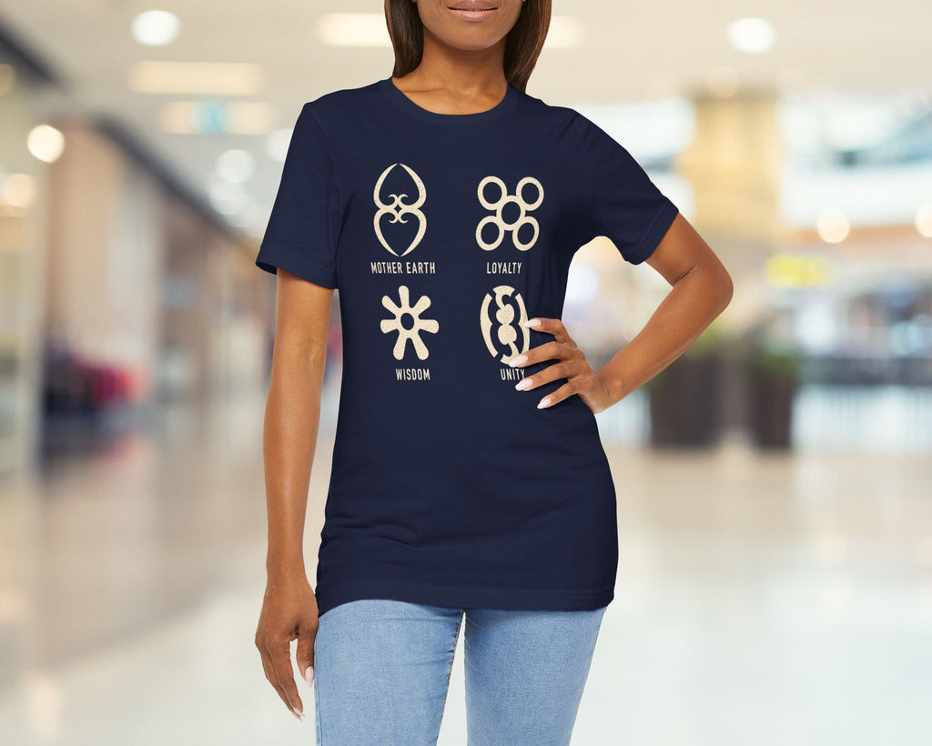 Woman wearing a navy blue t-shirt with symbols and text in a blurred indoor setting