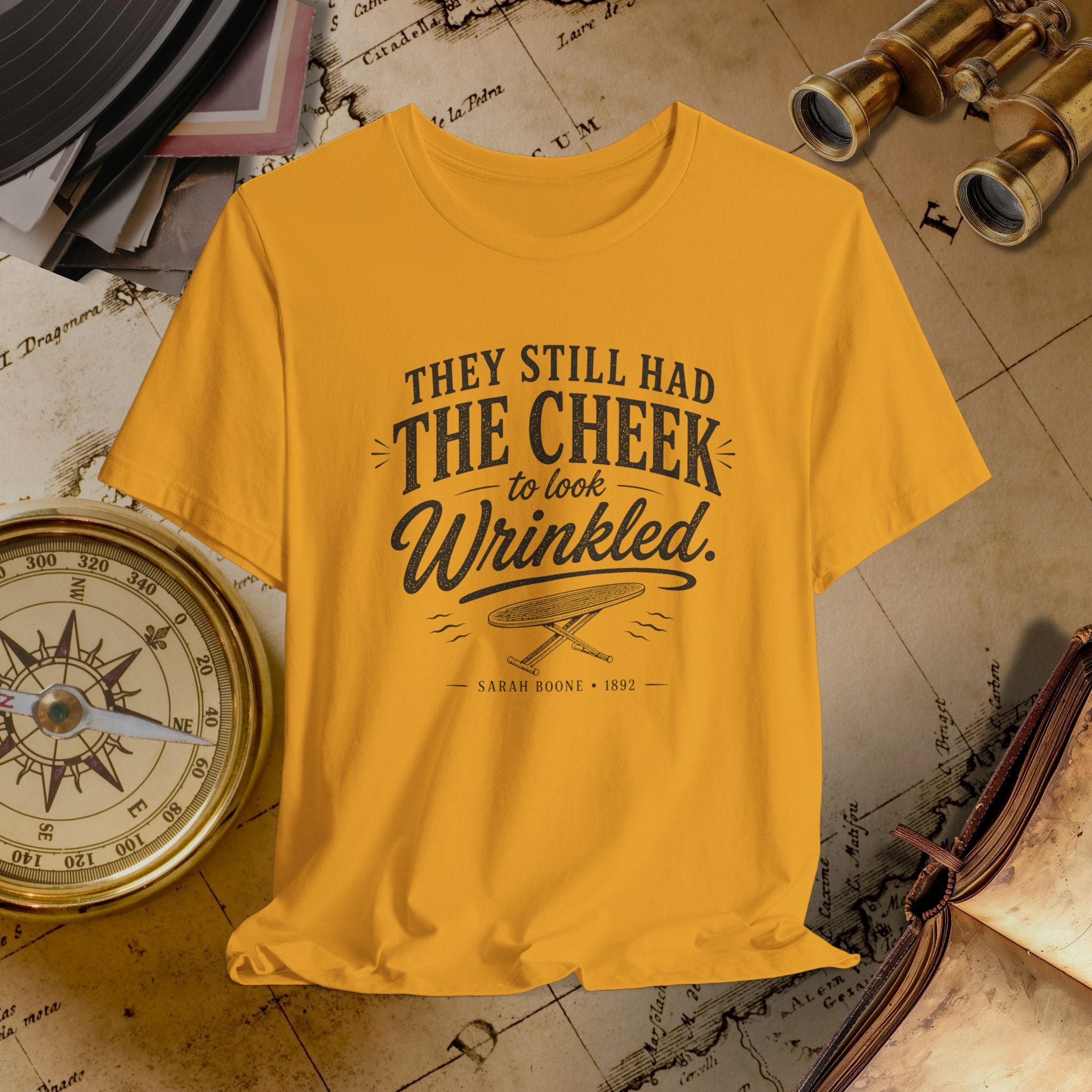 Mustard t-shirt with text and graphic on a vintage map background