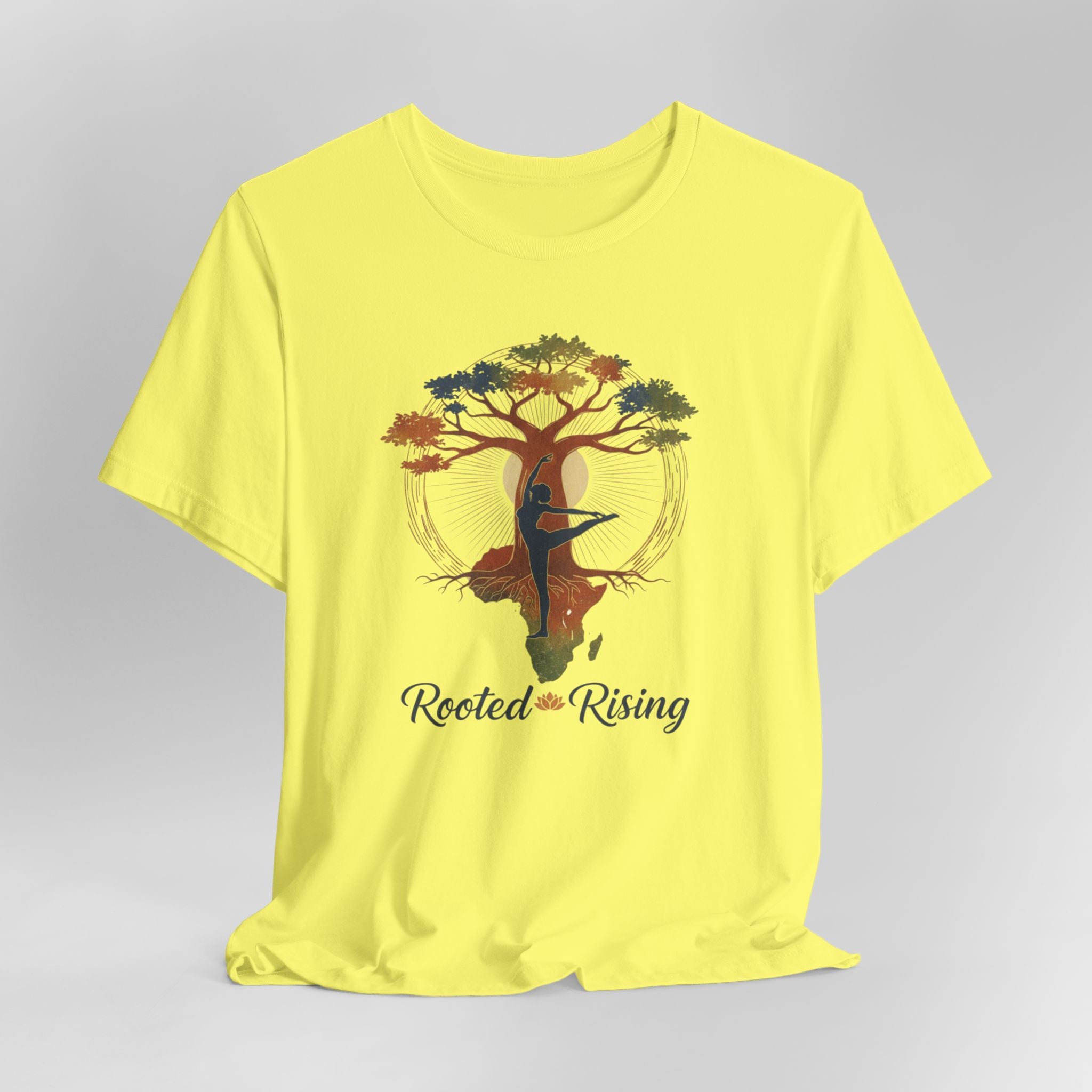 Yellow t-shirt with a tree and dancer graphic and 'Rooted and Rising' text on a gray background