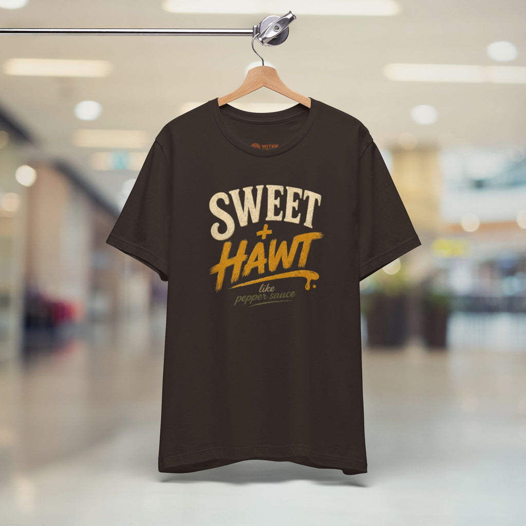 Brown t-shirt with text on a hanger in a store setting